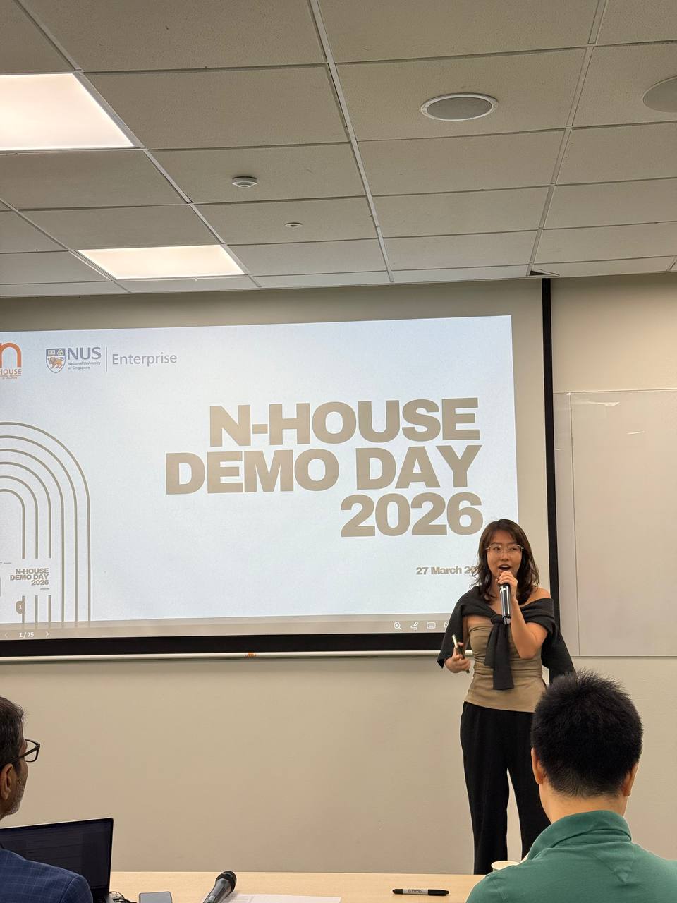 Jocelyn hosting NUS N-House Demo Day with a microphone